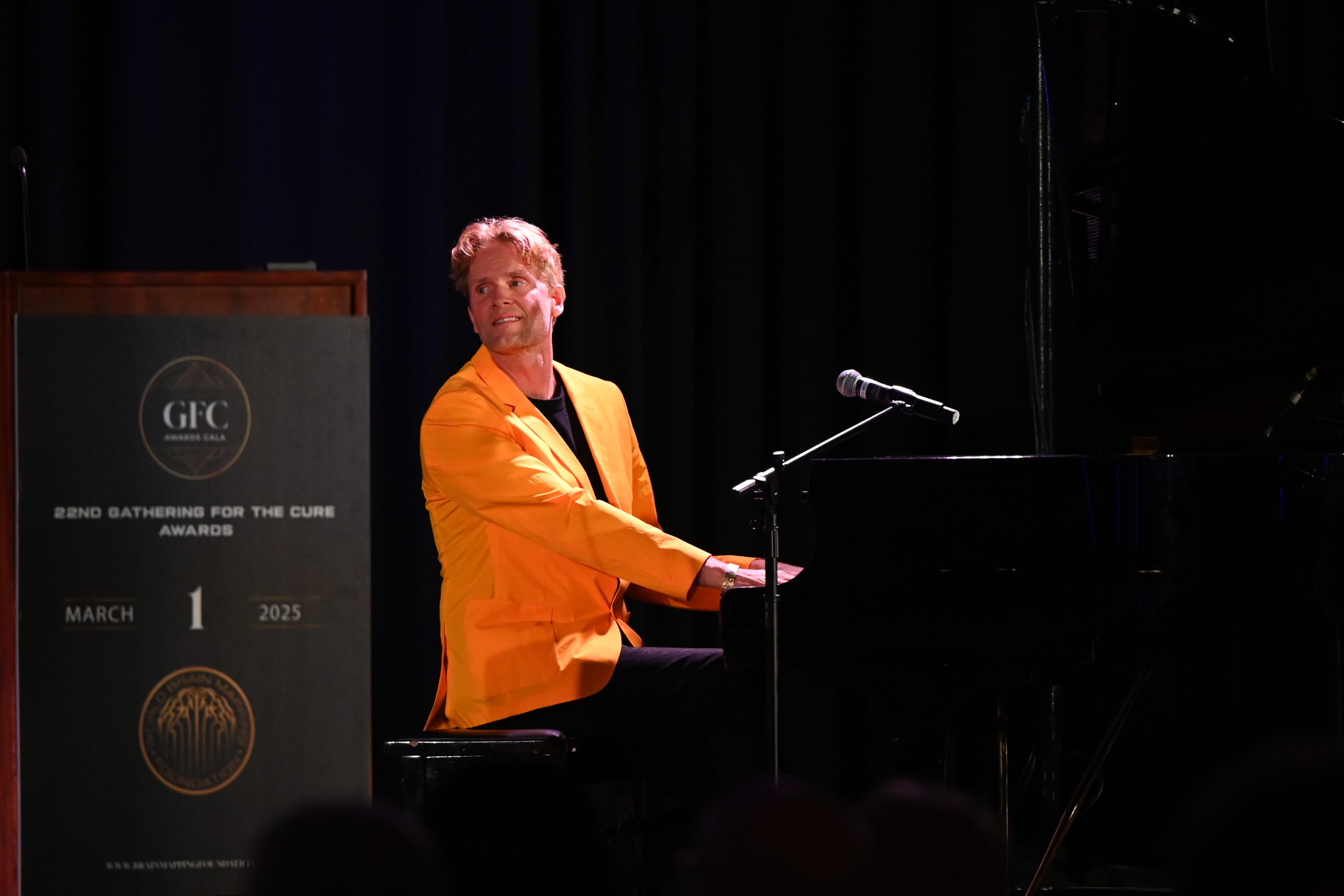 Toby Gad performing on stage